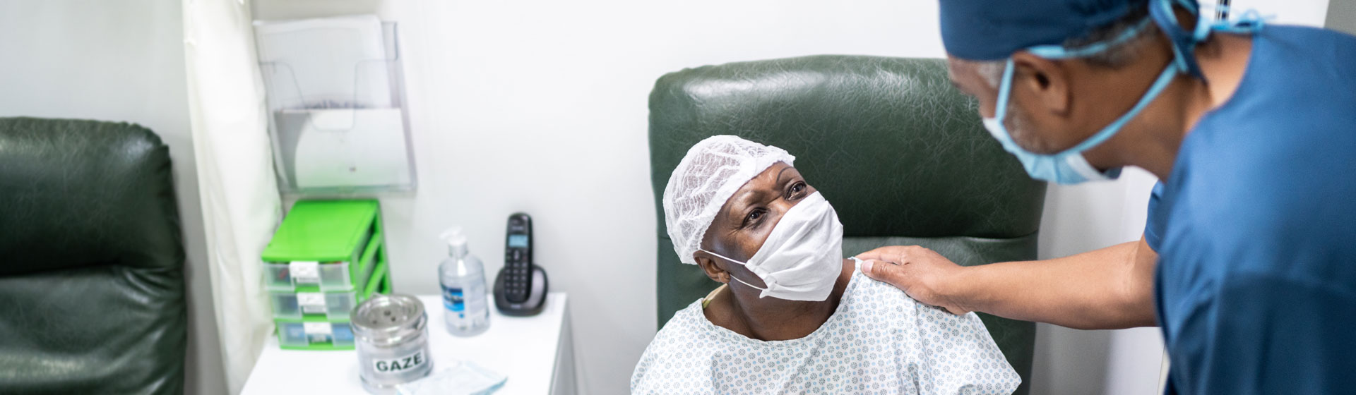 Doctor comforting patient wearing a mask